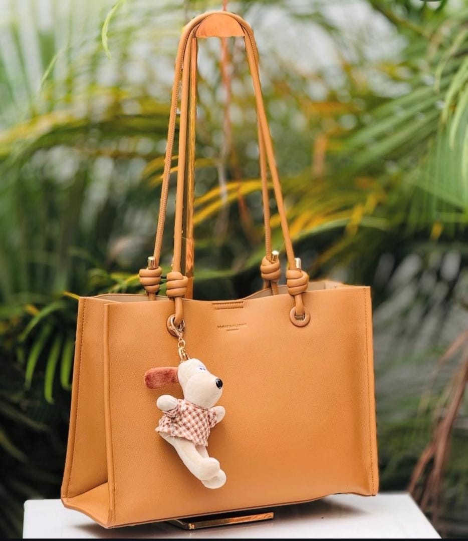 Chic Knot-Strap Tote Bag with Plush Puppy Charm is an elegant daily tote bag featuring a structured rectangular shape, distinctive knotted double-shoulder straps, clean minimalist lines, a playful detachable plush dog keychain charm