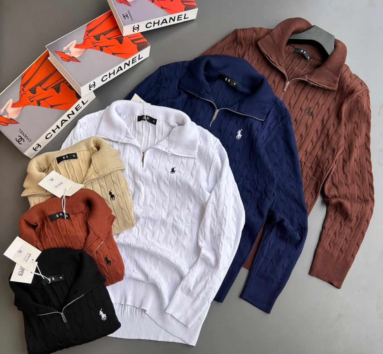 Ralph Lauren Cable-Knit Quarter-Zip Sweaters feature a classic textured cable weave, silver-tone zip closure, high collar, and signature embroidered chest logo, available