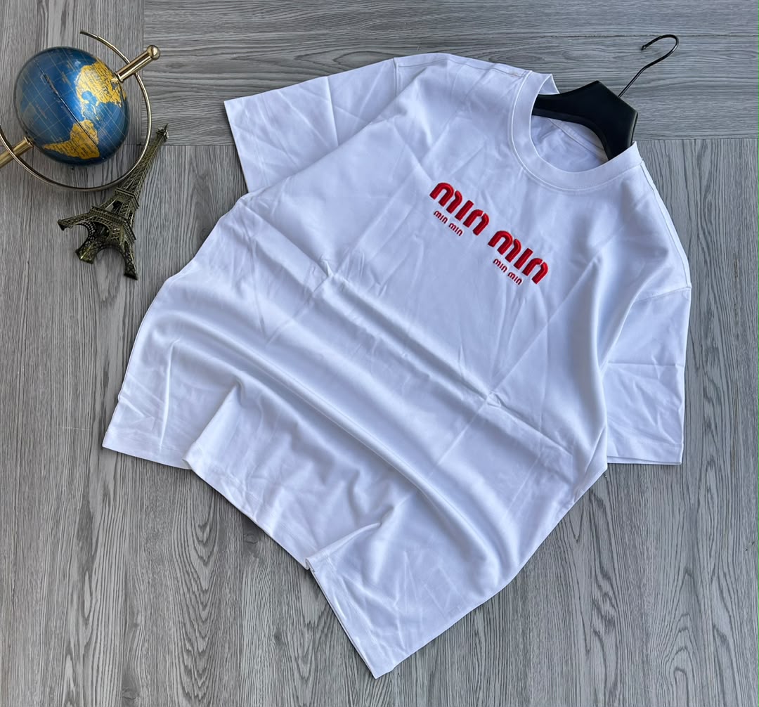Features a vibrant, multi-color paint-splatter compass rose graphic printed on the left chest. Crafted from a thick cotton fabric, making it a casual streetwear piece.